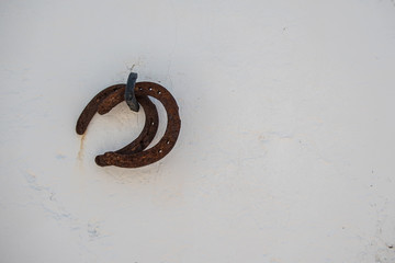 Herradura de caballos sobre pared de cal blanca