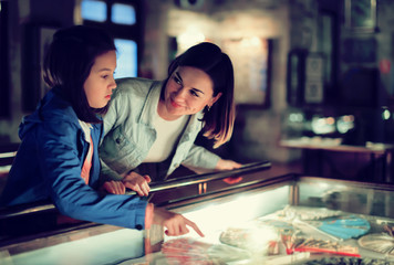 Mother and daughter pointing at sight during