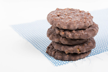 Stack of chocolate nut cookies on raw material