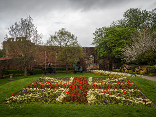 Flowers in the shape of the Union Jack in front of a castle, Shrewsbury, Shropshire, UK.