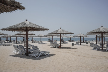 Dubai. Heavenly oasis in Ras al Khaimah. The beach with sunbeds and sunshades in Dubai, on the...
