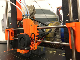 3D Printing Machine printing a piece of plastic. Working 3d printer.