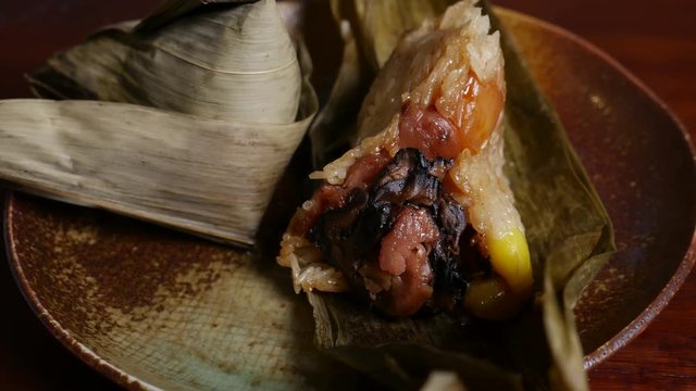 'Zongzi' or 'bakcang', 'bacang' a Chinese traditional food made of glutinous rice  with different fillings and wrapped in bamboo or large leaves.