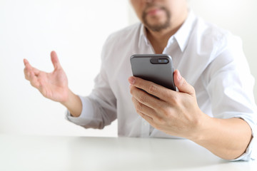Big data analytics with business intelligence (BI) concept. businessman using mobile phone and laptop computer on white desk