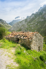 Beautiful nature of Spain: Picos de Europa mountain peaks and tourist trails in summer sunny day with blue sky and clouds