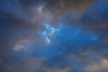 Fototapeta na wymiar Dark clouds in the evening azure sky (background)
