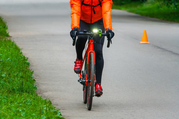 Bicyclist on the asphalt road in the park