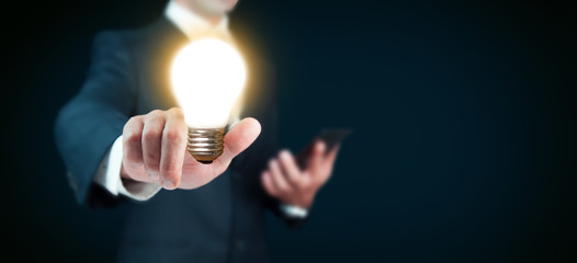 Light bulb in hand businessman