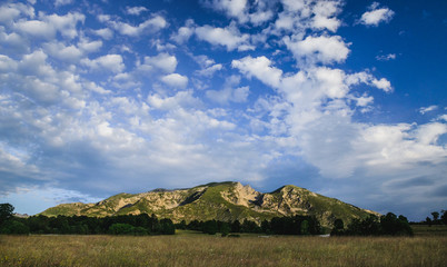 Clouds on the blue sky above the mountain