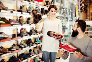 Fototapeta na wymiar Couple deciding on new sneakers