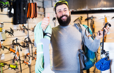Man choosing climbing equipment