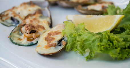 Baked mussels with lettuce leaves