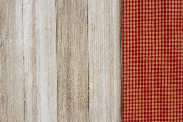 Retro checkered cloth on weathered wood background