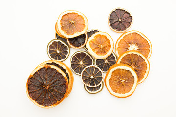 Pile of dried citrus circles lying on white table