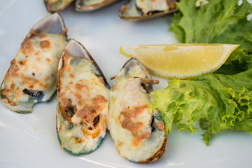 Yummy mussels under cheese and lemon