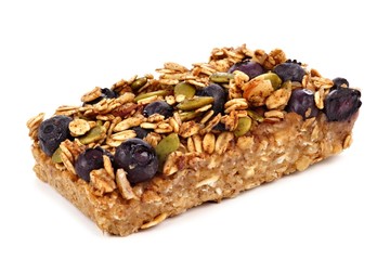 Homemade superfood breakfast bar with oats and blueberries isolated on a white background