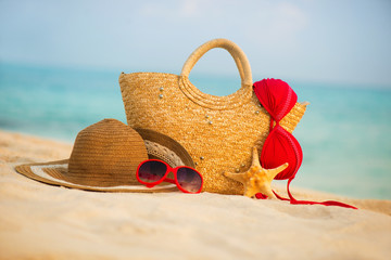 Summer beach with accessories. Blur azure sea on background