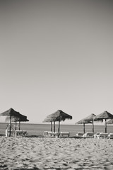 Sunny sky and chairs with parasol on the beautiful beach of Portugal