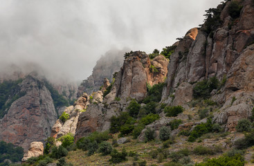 Clouds passing below the top of the mountain. Rocks of unusual shape