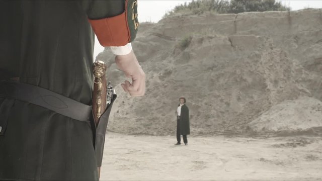 Duel between men's affair of honor. Two people with guns, duel. Cowboys. Wild West Duel close up