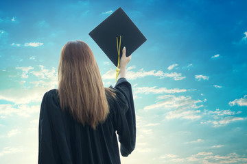 student graduate holding certificated in hand with sky background
