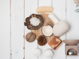 Fototapeta na wymiar Aromatherapy product Spa set ,candle ,soap,coconut, massage with white wood background. top view,flat lay composition.