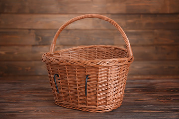 Fototapeta na wymiar Bicycle wicker basket on wooden table