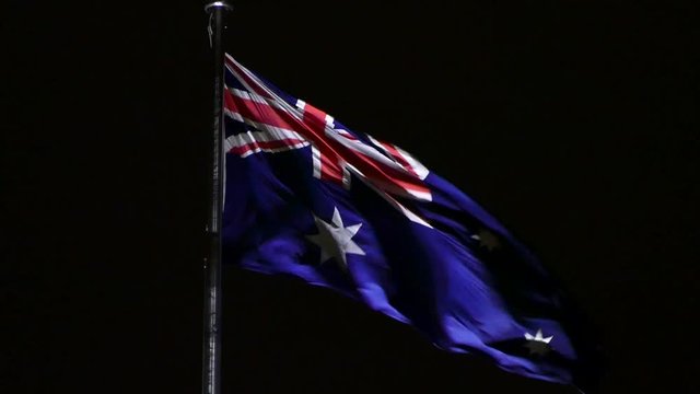 Australian Flag on top of Parliament House Canberra at night. 