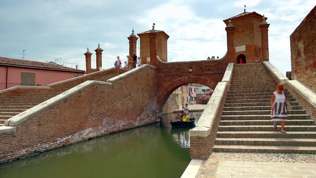 view of venetian gondola coming from three way bridge, one of the few bridges in the world with this structure, in Italy, color graded clip