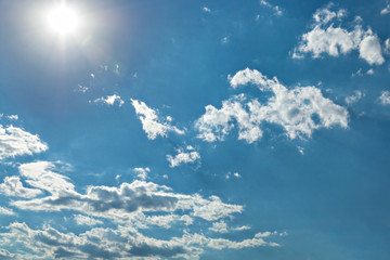 Bright sun, White heap clouds and bright sun in the blue sky.