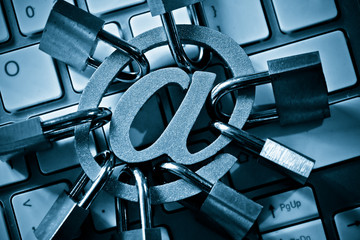 Email sign with many padlocks on computer keyboard / Email encryption security and countermeasure...