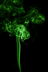 Green smoke movement on black background.