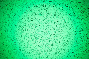 Rain droplets on green glass background, Water drops on glass.