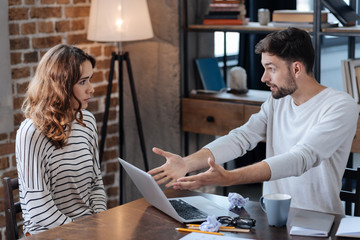 Unhappy angry man pointing at the laptop