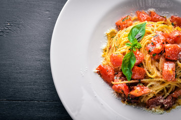 Pasta tomatoes. Italian traditional food. On a wooden background. Top view. Free space for your text.