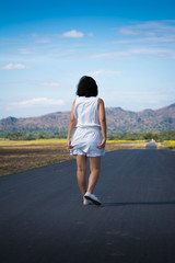 woman walking alone on the road