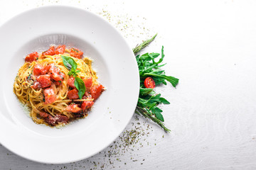 Pasta tomatoes. Italian traditional food. On a wooden background. Top view. Free space for your text.