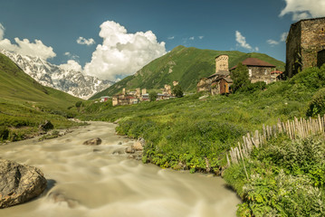 Long exposure view of village Ushguli with old stone towers under the highest georgian mountain Shkhara with glacier in Svaneti, Caucasus, Georgia