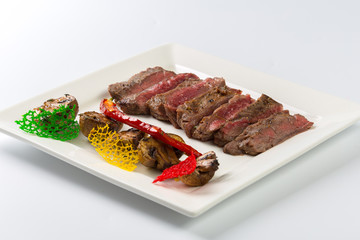 Juicy steak medium rare beef with spices and grilled vegetables