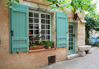 Fototapeta na wymiar Window with shutters and door in provence style with original lantern
