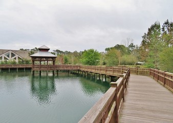 Fototapeta na wymiar Gazebo and wooden boardwalk over a lake