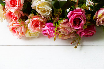 Roses are on  white wooden background