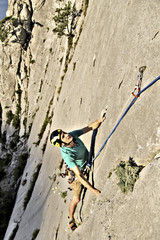 Obraz na płótnie Canvas Rock climber reaching for his next hand hold, Joshua Tree National Park.