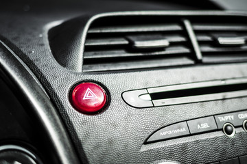 Red warning lights button on a black cockpit car © jordieasy
