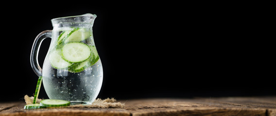 Cucumber Water on vintage wooden background