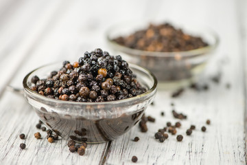 Preserved black Peppercorns on a wooden table