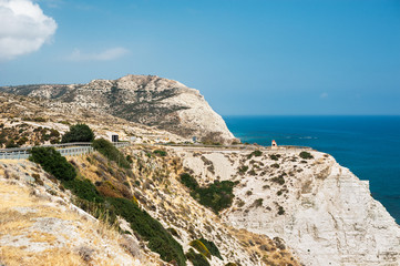 Fototapeta na wymiar The mountains, the sea, the sky and the road. Beautiful mountains in the Mediterranean sea. Seascape. Beautiful coast of Cyprus. Sky, mountains, sea. Road along the sea