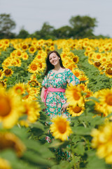 Fototapeta na wymiar Brunette girl in a field of sunflowers