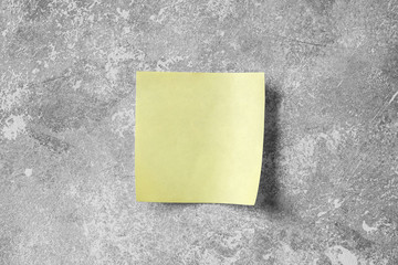 Stick note on grey concrete wall background