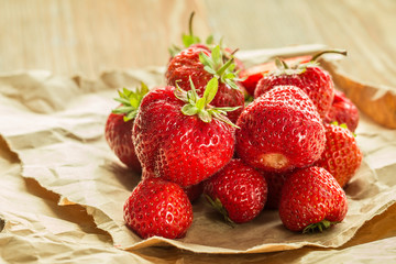 Ripe red strawberries on wooden table